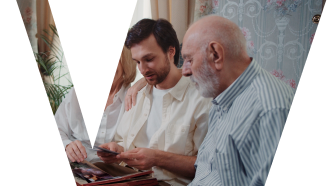 A senior man sitting with his son