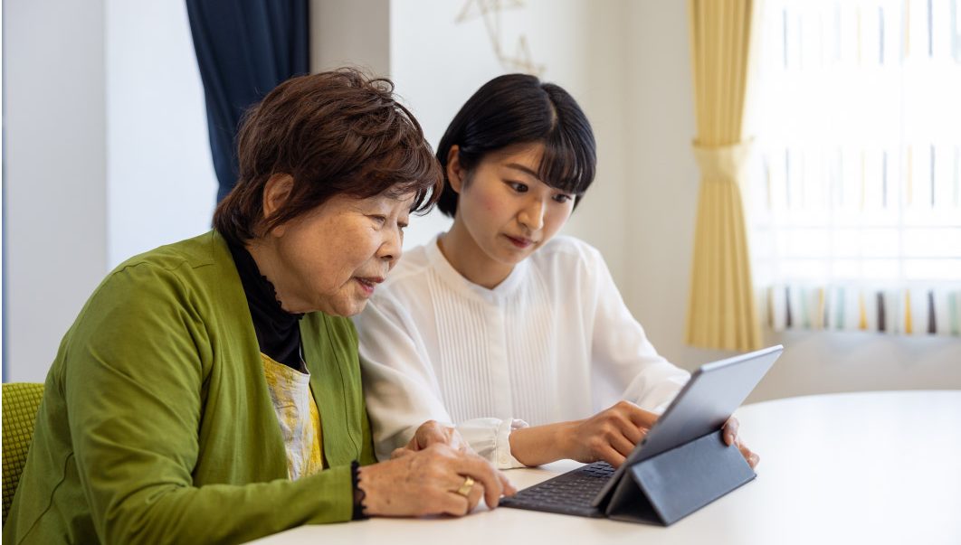 Bridging the Gap: Empowering Aging Loved Ones with Technology 1 Daughter helping her senior mother embrace technology.