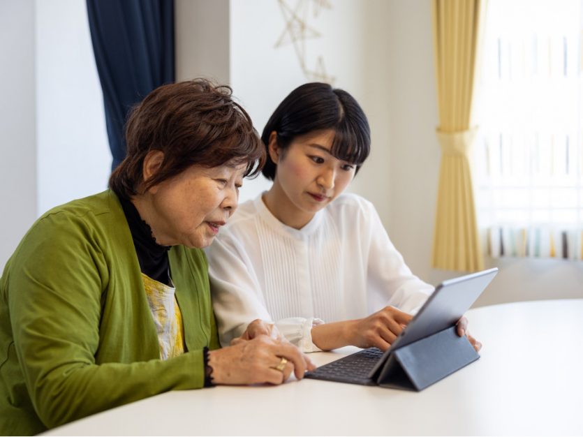 Daughter helping her senior mother embrace technology.