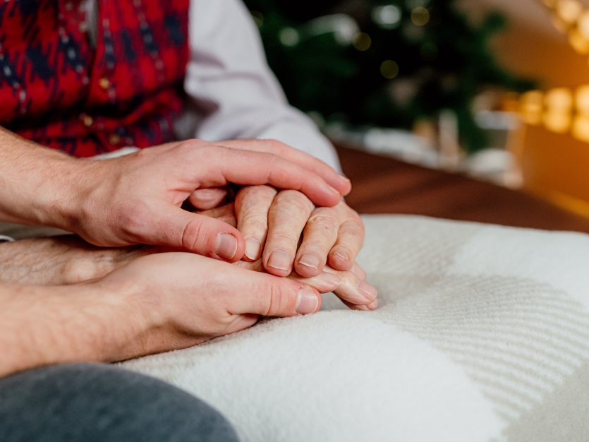 Holding the hands of an older adult - Discussing Home Care With Aging Parents