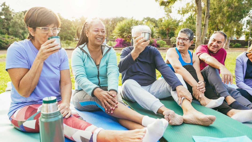 a group of people sitting on yoga mats