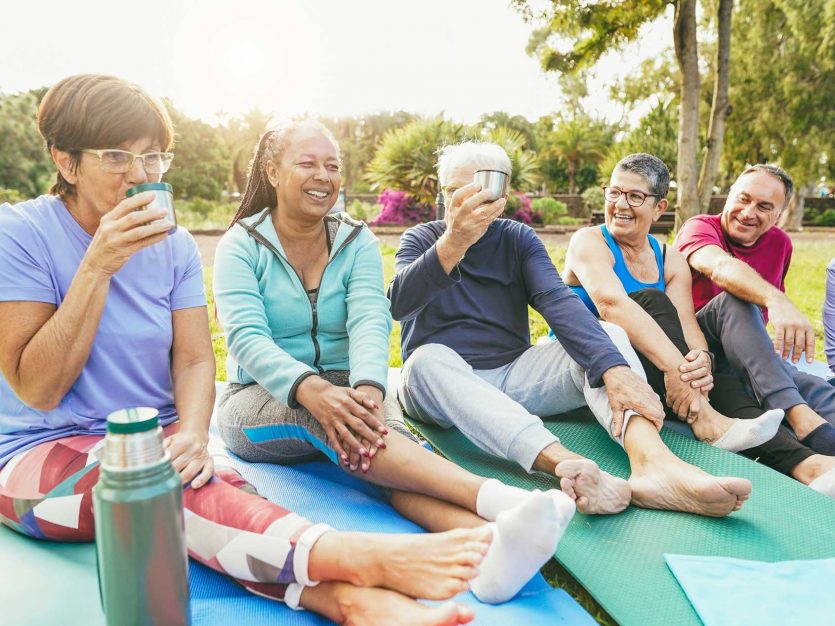 a group of people sitting on yoga mats