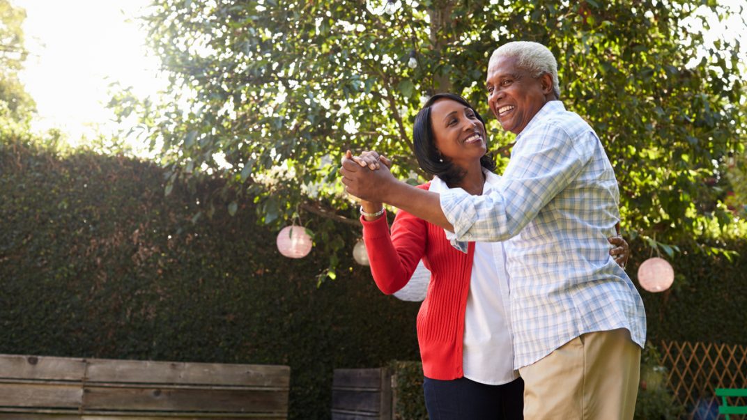 “Dancing” our way to fewer falls and better physical function? 1 Older adult couple ballroom dancing in their backyard.