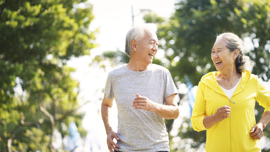 5 health conditions that can benefit from exercise 1 Male and female older adults running outdoors.