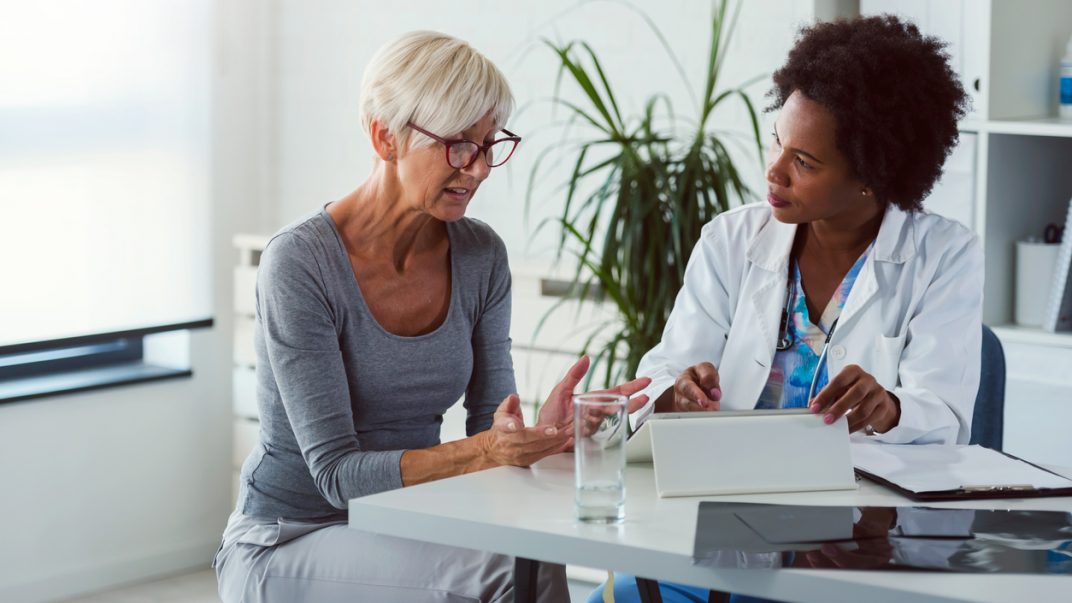 Heading home from the hospital? Caregivers can play an important role in the discharge process 1 Female caregiver speaking with female doctor in a doctor’s office.