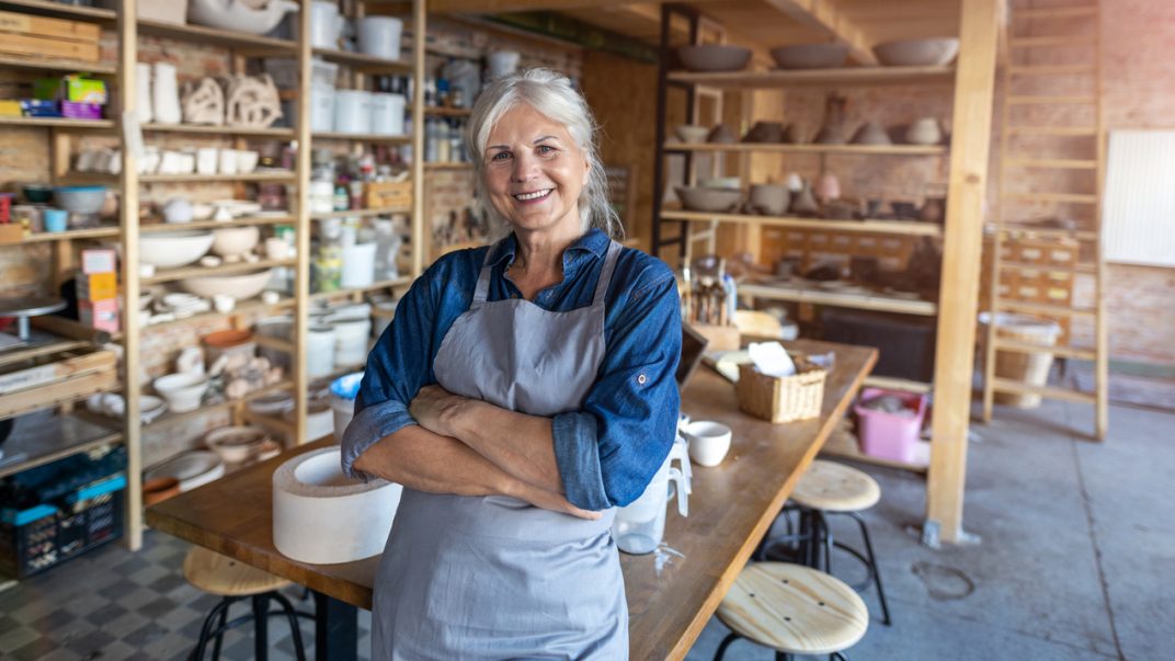 Reimagining Retirement 1 older woman standing in her pottery studio