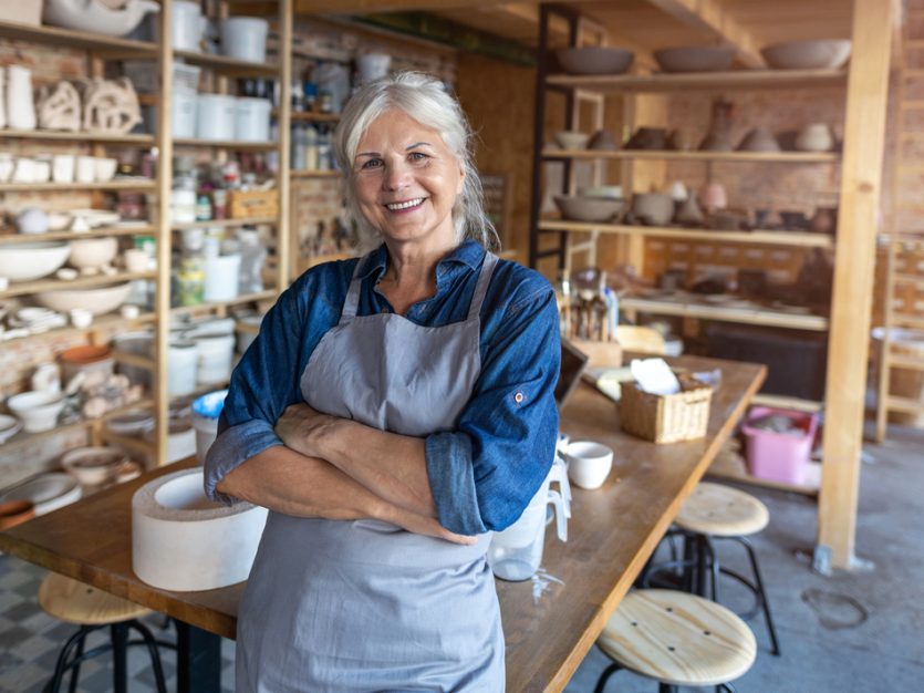 older woman standing in her pottery studio