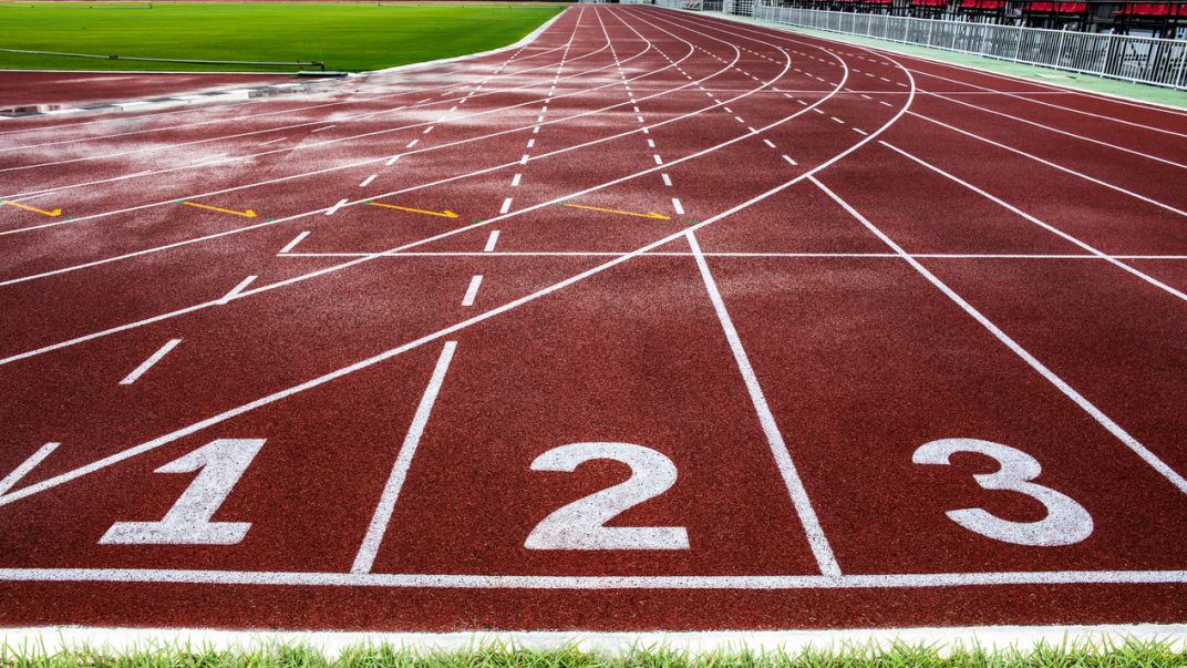 Competitive sports can be healthy at all ages 1 Starting line of red running track in a large stadium.