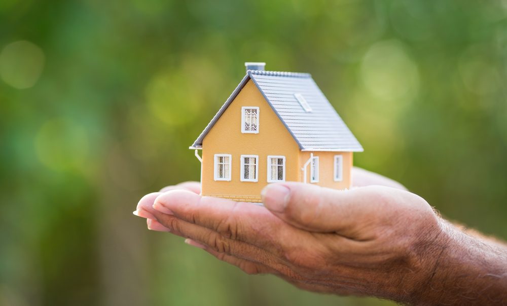 Aging in place: Spring into a safer, more comfortable home 1 A person holding a small house