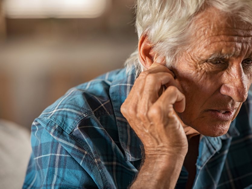 A man holding his ear