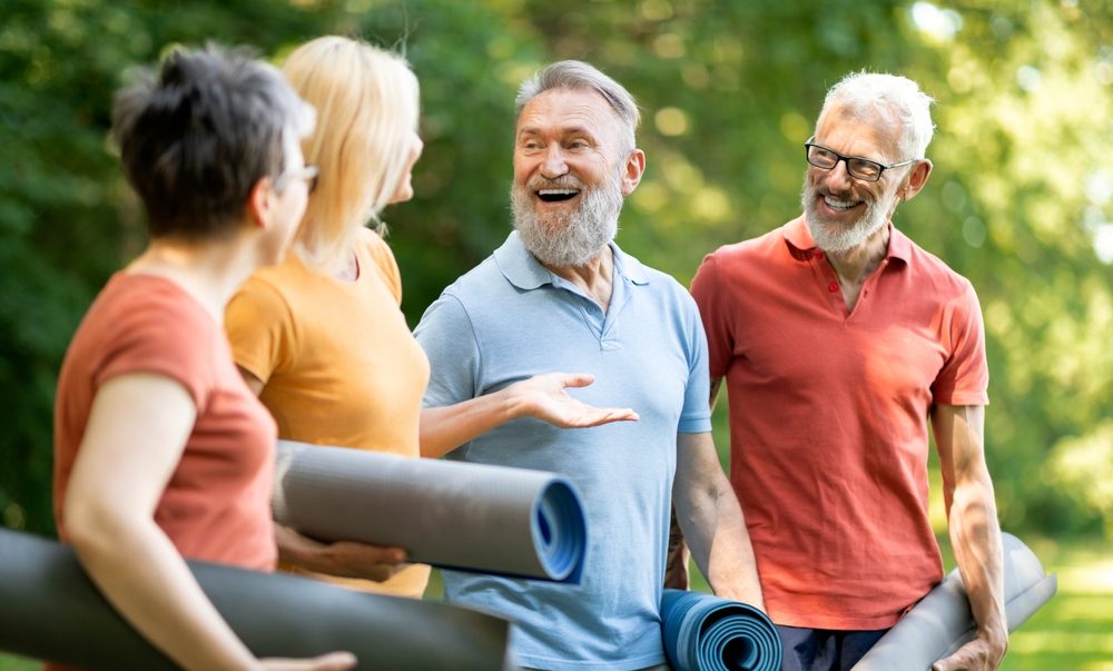 Group of older adults with yoga mats