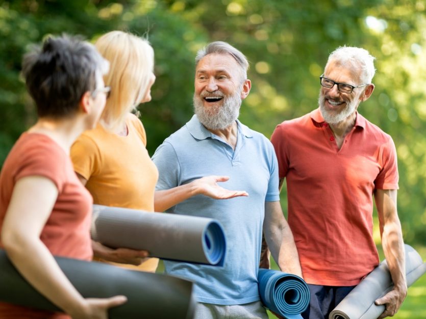 Group of older adults with yoga mats