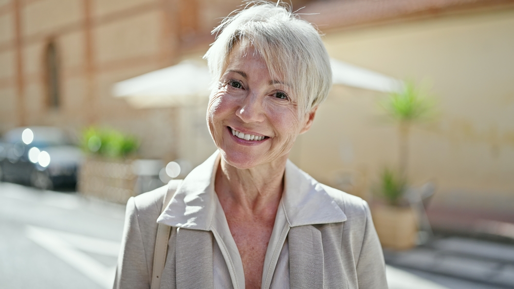Happy senior woman smiling while being outdoors