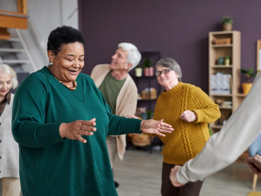 Group of older adults dancing.