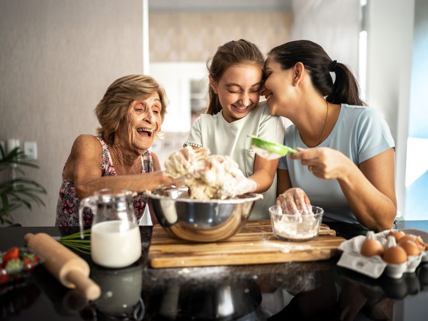 Senior, granddaughter and adult daughter baking - Three Viral Holiday Treats to Make Together This Season
